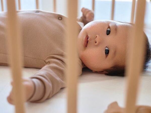 Newborn lying on his bed at home